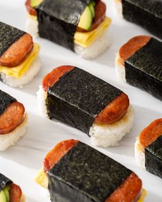 sushi rolls are arranged on a white plate