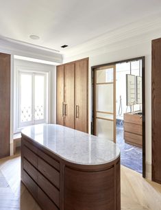 an empty kitchen with marble counter tops and wooden cabinets