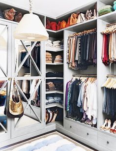 an open closet with clothes hanging on it and a lamp in the corner next to it that says, this is what the perfect house looks like, according to pinterest