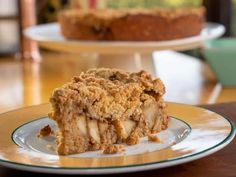 a piece of apple crumb cake sitting on top of a white and yellow plate