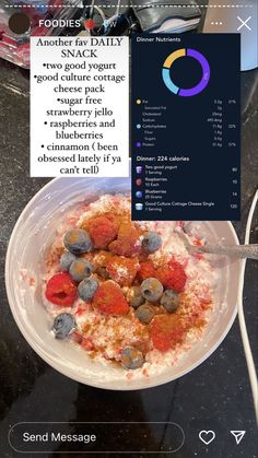 a bowl of cereal with blueberries and raspberries in it on a table