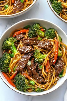 three bowls filled with beef, broccoli and noodles