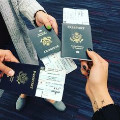 three people are holding their passport and boarding cards