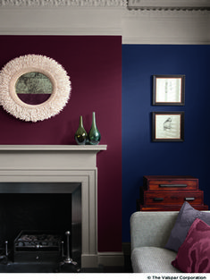 a living room filled with furniture and a fire place next to a wall mounted mirror