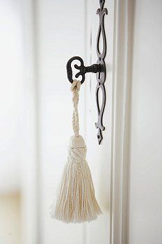 a door handle with a tassel hanging from it