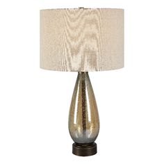 a table lamp with a white shade on it and a wooden base in the shape of a vase