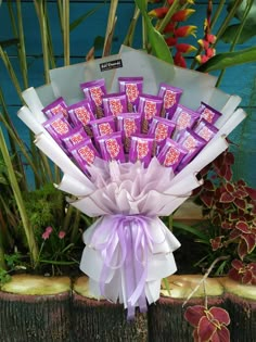 a bouquet of chocolates wrapped in purple ribbon