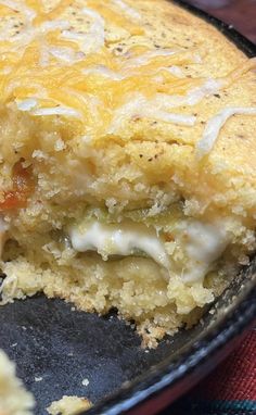 a close up of a casserole in a pan with cheese and onions on it