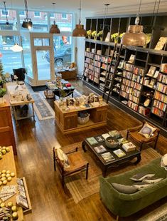 a living room filled with lots of furniture and bookshelves full of different types of books