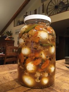 a jar filled with food sitting on top of a wooden table