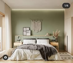 a bedroom with green walls and white bedding in the center, along with an area rug on the floor