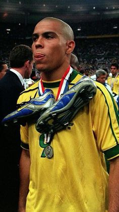 a soccer player is holding his glove in front of the crowd at a sporting event