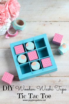 some cupcakes are in a blue box on a table with pink and white polka dots