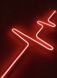 a red neon sign that is on top of a table