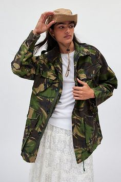 Original vintage utility jacket sourced by Urban Renewal. Oversized painter’s style utility jacket in an all-over camo print canvas in their original deadstock form. Each one will come to you as pictured. Features Urban Renewal Vintage camo painters utility jacket Original vintage jacket Camo print canvas High stand collar and long sleeves Double breasted hand and chest pockets Zip and snap placket Oversized fit Tunic length Deadstock style as pictured here Content + Care Cotton, polyester Machi Camouflage Utility Jacket With Pockets, Oversized Military Utility Jacket, Oversized Military Utility Jacket With Pockets, Military Camouflage Utility Jacket With Pockets, Military Style Camouflage Utility Jacket With Pockets, Camouflage Utility Jacket With Pockets For Streetwear, Camouflage Utility Jacket For Streetwear, Fall Combat Utility Jacket With Cargo Pockets, Long Sleeve Camouflage Utility Jacket