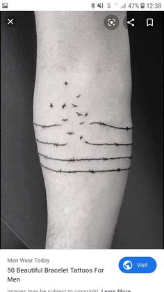 a man's leg with barbed wire and stars on the side of his calf