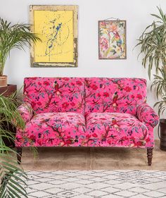 a living room filled with furniture and plants