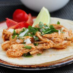 a tortilla topped with chicken and garnished with cilantro