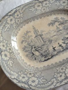 an antique plate with blue and white designs on it