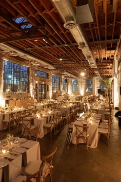 a large room with tables and chairs set up for an event or function in the center