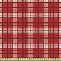 a red and white checkered fabric with a ruler in front of the plaid pattern