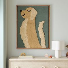 a dog is sitting on top of a dresser next to a lamp and teddy bear