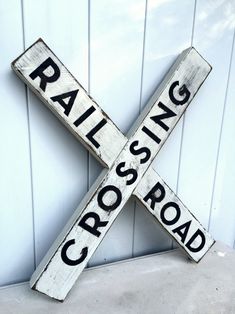 a railroad crossing sign on the side of a building