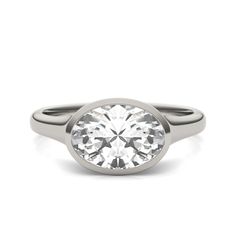 a white gold ring with a round cut diamond