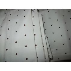 two white sheets with brown polka dots on them