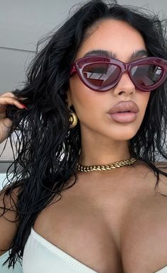 a woman with large breast wearing sunglasses