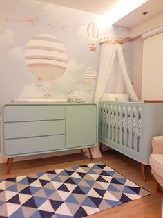 a baby's room with a crib, dresser and bed in the corner