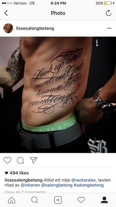 the back of a man's stomach with some writing on it