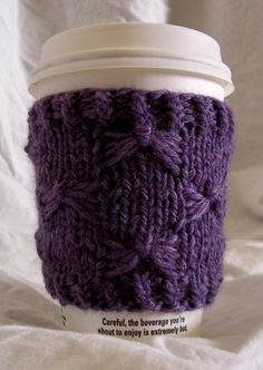 a knitted coffee cup cozying in purple