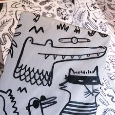 a bed topped with sheets covered in cartoon drawings