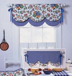 the kitchen is decorated in blue and white with flowers on the window valances