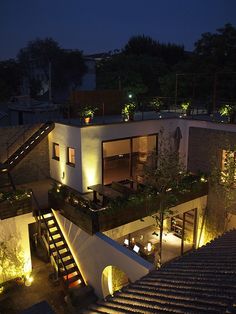 an aerial view of a house at night with stairs leading up to the upper level