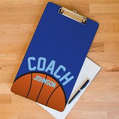 a clipboard with the word coach written on it next to a pen and ball