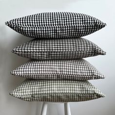 three black and white pillows stacked on top of each other