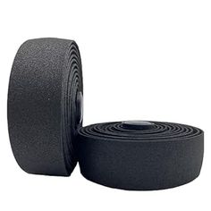 two rolls of black foam tape on white background