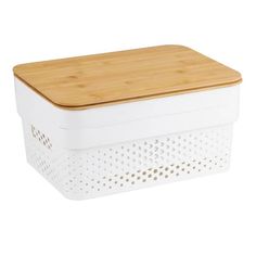 a wooden cutting board sitting on top of a white container