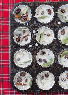 cupcakes with white frosting and pine cones on a baking tray, ready to be eaten