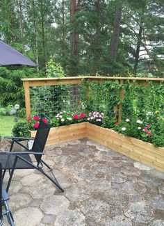 a patio with an umbrella and some flowers