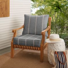 a chair sitting on top of a wooden floor next to a bag and a hat