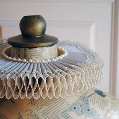 This majestic elizabethan ruff collar is made with rich brocade in beige  and it is trimmed with beige lace edge. It is further embellished with pearls that go all around the neck, creating a rich accessory to compliment your renaissance costume. Measurements : Width: 3 inches (7.5 cm) Height: 1.5 inches (4 cm) For a complete look this collar may be combined with this headpiece: https://www.etsy.com/listing/567711159/tudors-headpiecebeige-attifet-hatfrench?ref=shop_home_active_17&frs=1 A standing version of this collar,a burgundy and beige version, as well as matching cuffs can also be found here: https://www.etsy.com/shop/BizarreNoir?ref=seller-platform-mcnav%C2%A7ion_id&section_id=14329954 This item is sent packaged securely and sent out with DHL Express, delivered in 2-6 days depending Costume Collar, Elizabethan Ruff, Elizabethan Costume, Elizabethan Fashion, Elizabethan Collar, Ruff Collar, Mardi Gras Costumes, Neck Jewellery, Costume Shop