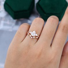 a woman's hand with a ring on it and two diamonds in the middle