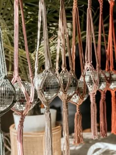 several disco balls hanging from the ceiling with tassels