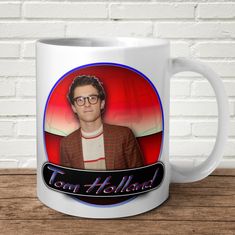 a white coffee mug with a photo of tom holland on it