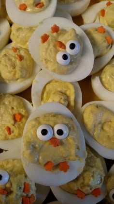 some deviled eggs with googly eyes and carrots on them are ready to be eaten