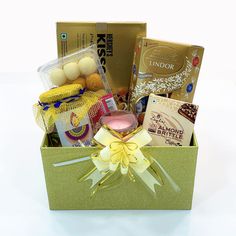 a box filled with lots of different types of food and snacks on top of a table