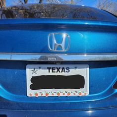 a license plate on the back of a blue car